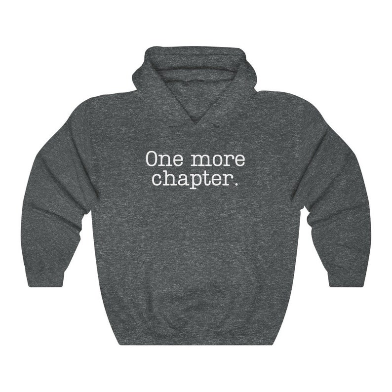 May include: A dark grey hooded sweatshirt with the text "One more chapter." printed in white on the front.