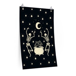 May include: A rectangular wall poster featuring a black background with a cream-colored crescent moon, numerous stars, and two skeletons dancing around a central cauldron emitting swirling smoke. The design is printed on a vertical orientation.