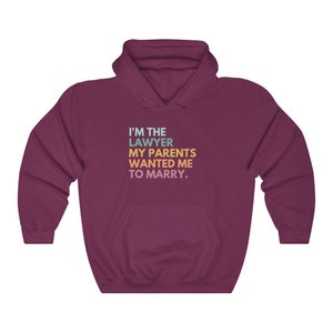 May include: Burgundy hooded sweatshirt with the text "I'm the lawyer my parents wanted me to marry."