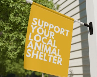 May include: A yellow flag with the text "SUPPORT YOUR LOCAL ANIMAL SHELTER" in white letters.