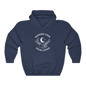 May include: Navy blue hooded sweatshirt with a white graphic design that says "Support Your Local Coven" with a crescent moon and stars.