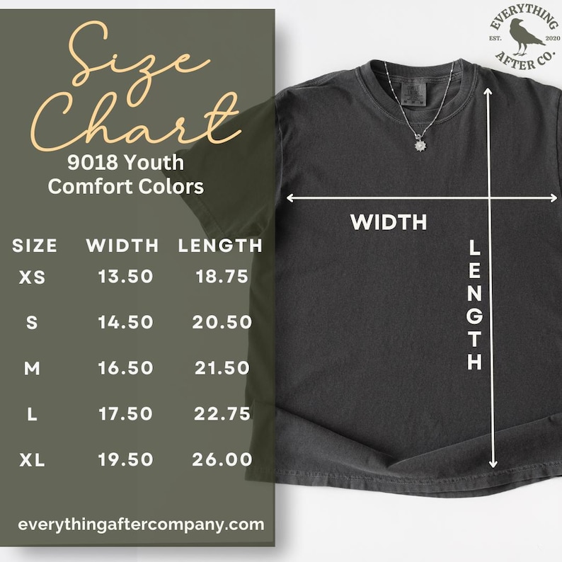 May include: A charcoal grey short-sleeve t-shirt displayed with a size chart overlay. The chart lists youth sizes XS through XL with width and length measurements in inches ranging from 13.50 to 26.00. A silver necklace rests on the shirt collar.