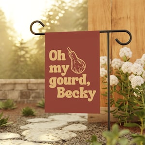 May include: A red garden flag with a yellow gourd and the text "Oh my gourd, Becky".