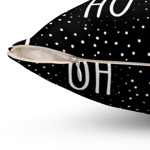 May include: Black throw pillow with white polka dots and the text "Home is where the oh is" printed on it. The pillow has a zipper closure.
