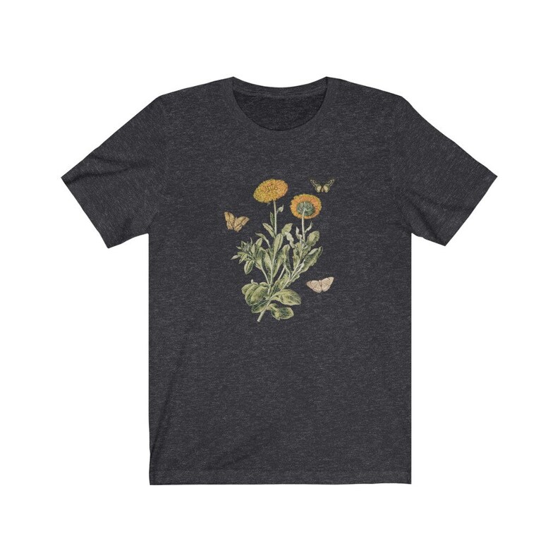 May include: A dark heather grey t-shirt with a vintage botanical illustration of a yellow flower with butterflies.