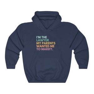 May include: Navy blue hooded sweatshirt with the text "I'm the lawyer my parents wanted me to marry."