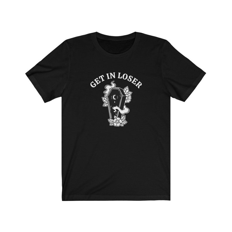 May include: Black t-shirt with white text that reads "GET IN LOSER" and a graphic of a coffin with a crescent moon and flowers.