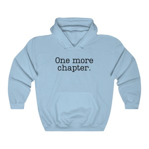May include: Light blue hooded sweatshirt with the text "One more chapter." printed in black.