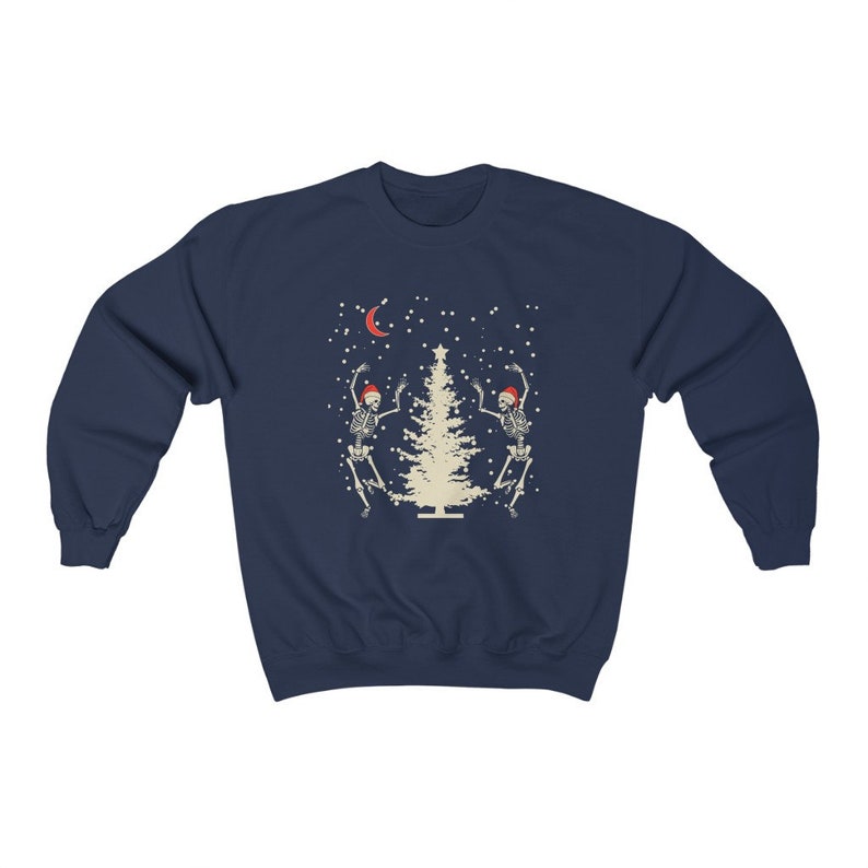 May include: Navy blue sweatshirt with a Christmas tree and two skeletons dancing around it. The skeletons are wearing Santa hats. The design is in a vintage style.
