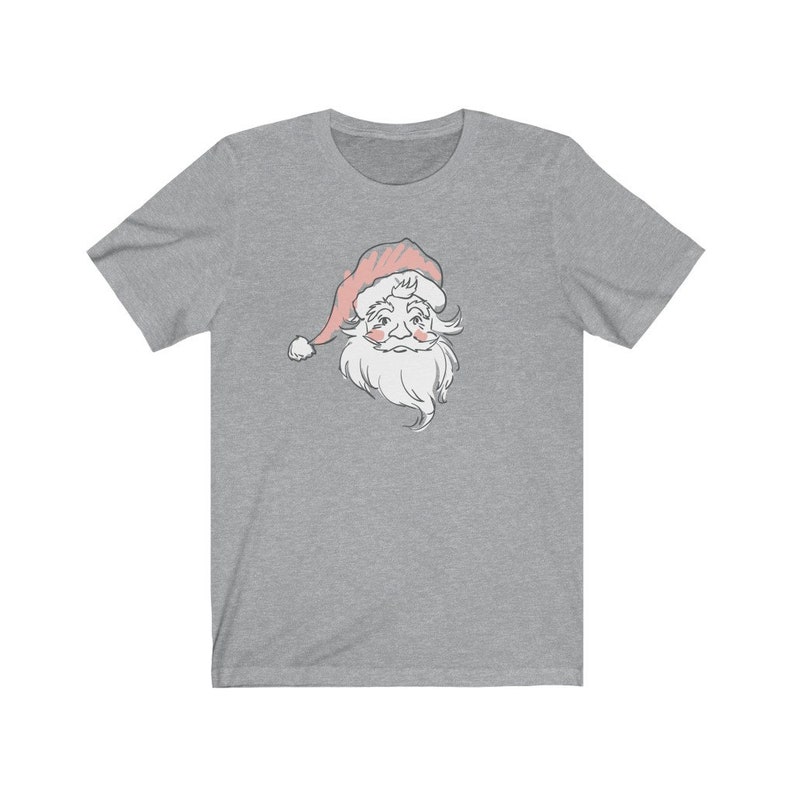 May include: A heather gray t-shirt with a vintage-style illustration of Santa Claus's face. The illustration is in shades of gray and pink.
