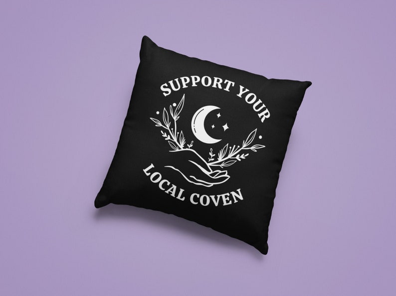 May include: Black throw pillow with white text that reads "Support Your Local Coven" and a crescent moon with stars and floral design.