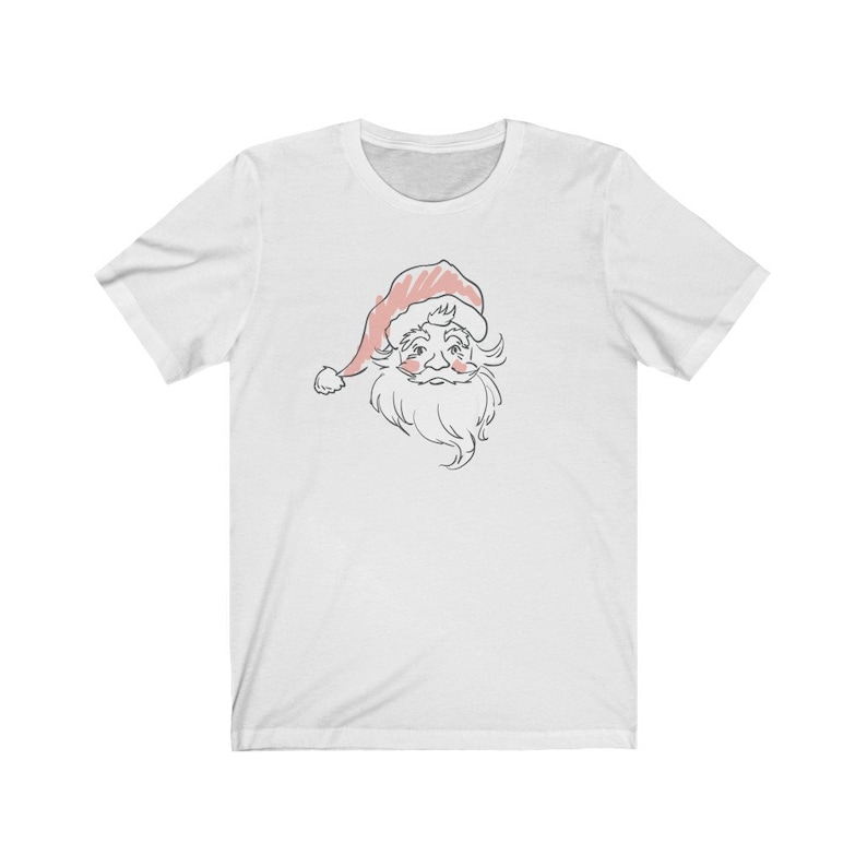 May include: White t-shirt with a line drawing of Santa Claus's face in pink and gray. Santa is wearing a red hat and has a white beard.