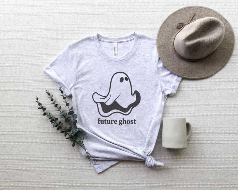 May include: A gray t-shirt with a black and white ghost graphic and the text "future ghost" printed on the front.