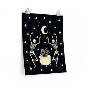 May include: A rectangular wall poster featuring a black background with a cream-colored crescent moon and stars. Two skeletons are depicted dancing around a central cream-colored cauldron emitting swirling smoke, all rendered in a flat graphic style.