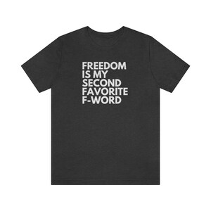 May include: Dark heather grey t-shirt with white text that reads "Freedom is my second favorite F-word".