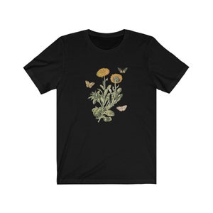 May include: Black t-shirt with a vintage botanical illustration of yellow flowers and butterflies.