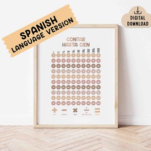 May include: A framed educational print with the text "CONTAR HASTA CIEN" and numbers from 1 to 100 in a grid. The print has a neutral color palette with a "SPANISH LANGUAGE VERSION" banner and a "DIGITAL DOWNLOAD" icon.