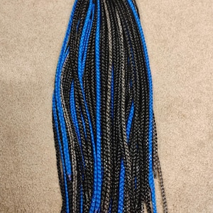 May include: A bundle of black and blue synthetic braiding hair. The hair is pre-braided and ready to be installed.