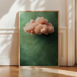 May include: A framed print of a fluffy pink cloud against a green background.