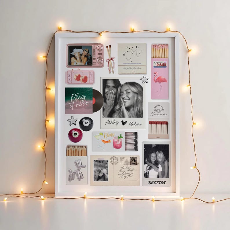 May include: A white framed collage featuring various decorative elements. Includes photos, matchboxes, a vinyl record, and a pool ball. The collage is adorned with string lights and the text "Ashley &hearts; Selena" and "Besties".