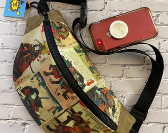 May include: A beige fanny pack with a black zipper and adjustable strap. The front of the pack features a colorful print of Japanese samurai warriors.