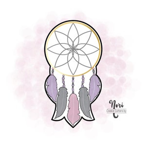May include: A gold dreamcatcher cookie cutter with a geometric design and purple and pink feathers. The cookie cutter is on a pink and white watercolor background. "Nori Cookie Cutters by" is written in black text at the bottom right of the image.
