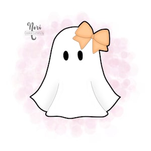 May include: A white ghost cookie cutter with a peach-colored bow on top. The ghost has two black eyes and a simple, rounded shape.