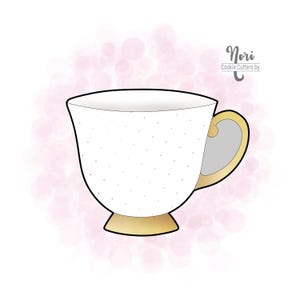 May include: A white teacup cookie cutter with gold detailing and small polka dots. The handle and base are gold, and the cup has a simple, elegant design. The text "Nori Cookie Cutters by" is in the upper right corner.