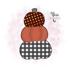 May include: A stack of three pumpkin cookie cutters. The top cutter is brown with gold polka dots, the middle cutter is orange, and the bottom cutter is black and white checkered.