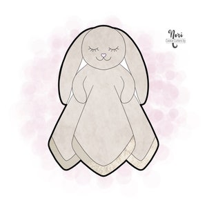 May include: A gray bunny cookie cutter with closed eyes and a pink nose. The cutter is shaped like a bunny holding a blanket. The text "Nori Cookie Cutters by" is in the top right corner of the image.