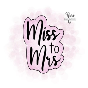 May include: A pink cookie cutter with a white background. The cookie cutter is shaped like a cloud and says "Miss to Mrs" in black script.