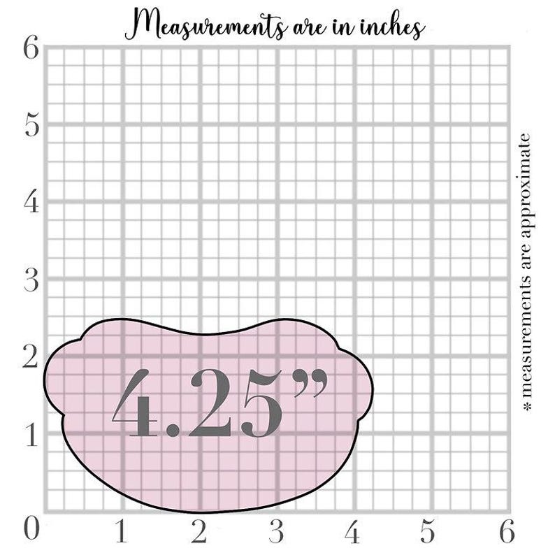 May include: A pink, bean-shaped cookie cutter with the measurement "4.25"" displayed in the center. The image includes a grid background and the text "Measurements are in inches" and "* measurements are approximate".