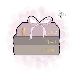 May include: A cookie cutter design featuring a stack of three books tied with a pink bow. The books are in shades of pink and gray, with gold lettering that reads "Once Upon a Time". The design is on a white background with pink bokeh.