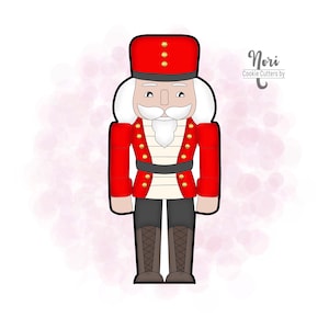 May include: A red and white cookie cutter shaped like a traditional nutcracker. The nutcracker has a black hat with gold accents, a white beard, and a black belt. The cookie cutter is labeled "Nori Cookie Cutters by"