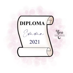May include: A black and white outline of a diploma scroll with the text "DIPLOMA" at the top, "Emma" in cursive writing below, and "2021" below that. The scroll is on a pink watercolor background with the text "Nori Cookie Cutters by" in the upper right corner.