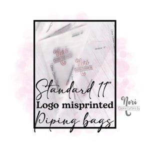 May include: Clear plastic piping bags with the text "Standard 11" and "Logo misprinted Piping bags". The bags have the "Nori Cookie Cutters by" logo. The image is framed in a black border.