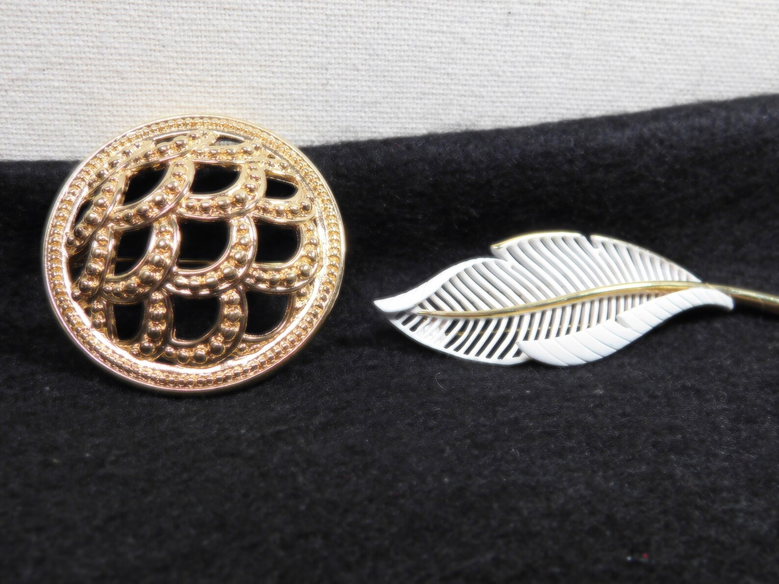 Vintage pins brooches a white enamel leaf and a round wave like