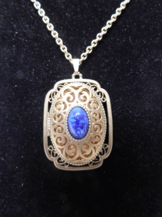 Avon Locket with Bright Blue Cabochon in Center