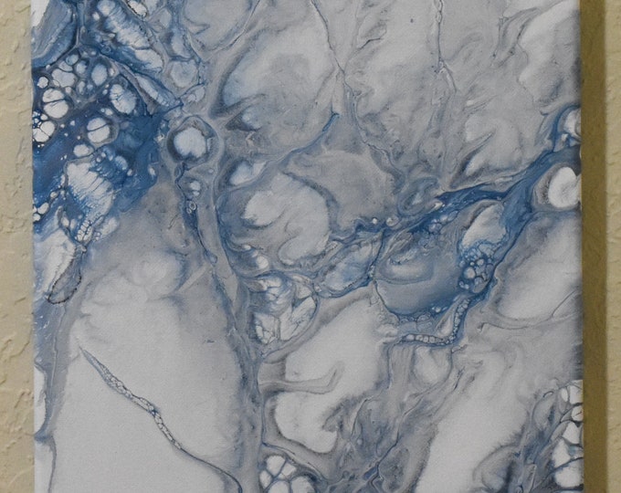 Frozen. Acrylic traveling flip cup cloud pour painting. 10" wide and 20" tall stretched canvas. Blue and silver swirls and clouds