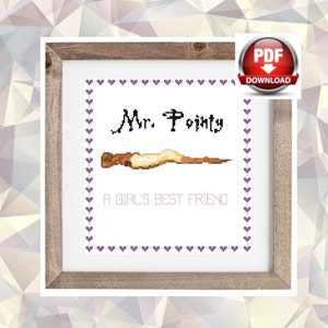 May include: Cross stitch pattern featuring a wand with the text "Mr. Pointy A Girl's Best Friend" in a white frame with a purple heart border.