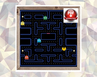 May include: A black and blue pixel art cross-stitch pattern of the Pac-Man video game maze. The pattern includes Pac-Man, four ghosts, and dots. The pattern is framed in a brown wood frame. The image includes the text "PDF DOWNLOAD".