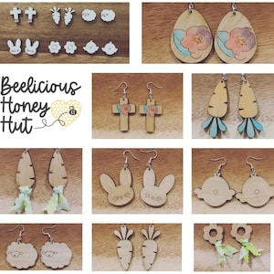 May include: Assortment of wooden earrings with various designs, including crosses, carrots, bunnies, clouds, flowers, and leaves. The earrings are painted in pastel colors and have a rustic, handmade look. The text "Beelicious Honey Hut" is visible in the image.