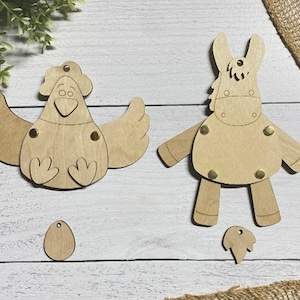 May include: Two unfinished wooden craft kits, one of a chicken and one of a horse. The chicken has wings, a head, and feet. The horse has a head, body, and legs. Both kits have holes for attaching embellishments.