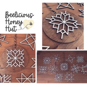 May include: A set of 12 wooden snowflake ornaments in white and brown. The ornaments are laser cut and have a geometric design. The ornaments are perfect for adding a touch of winter charm to your home decor.