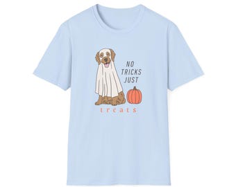May include: Light blue t-shirt featuring a cartoon dog dressed as a ghost with a pumpkin. The text reads "NO TRICKS JUST treats" in a playful font. A fun, Halloween-themed graphic tee.