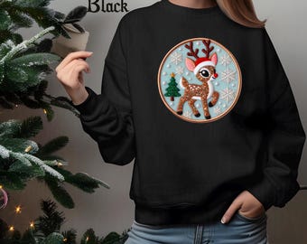 May include: Black sweatshirt featuring a festive reindeer design within a circular frame. The reindeer wears a Santa hat and is surrounded by snowflakes and a Christmas tree. The word "Black" is printed at the top.