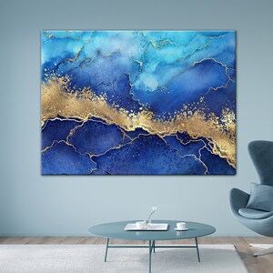 May include: Abstract art print featuring a blue and gold watercolor design. The print has a marbled effect with gold accents and a blue background.