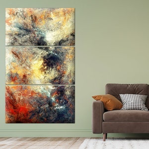 May include: A triptych of abstract art panels with a textured, multi-colored design. The artwork features shades of orange, red, yellow, gray, and blue. The panels are displayed above a brown sofa with throw pillows and a blanket, against a green wall.