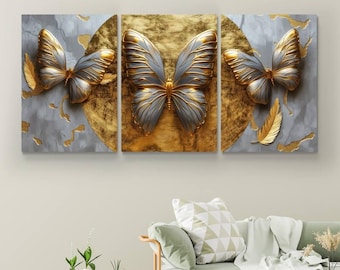 May include: A three-piece canvas wall art set featuring gold and silver butterflies on a textured background. The butterflies are arranged in a symmetrical pattern, with the centre butterfly being the largest.
