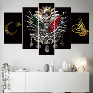 May include: A five-piece canvas print set featuring a stylized depiction of the Turkish coat of arms. The coat of arms is a silver and gold design with a crescent moon and star, a red and green flag, and a sword. The background is black.